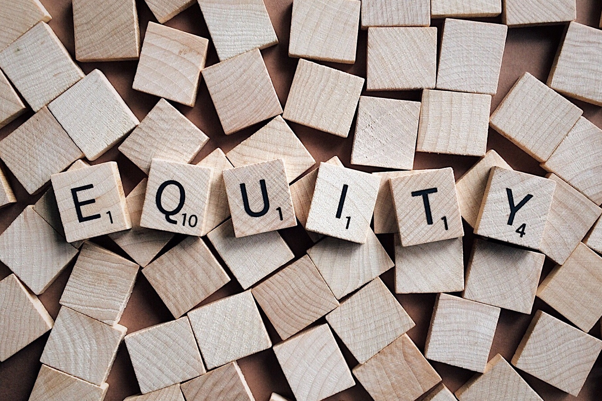 The word "equity" spelled out in scrabble letters