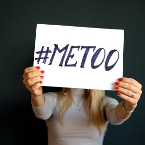 A woman holding a #metoo sign