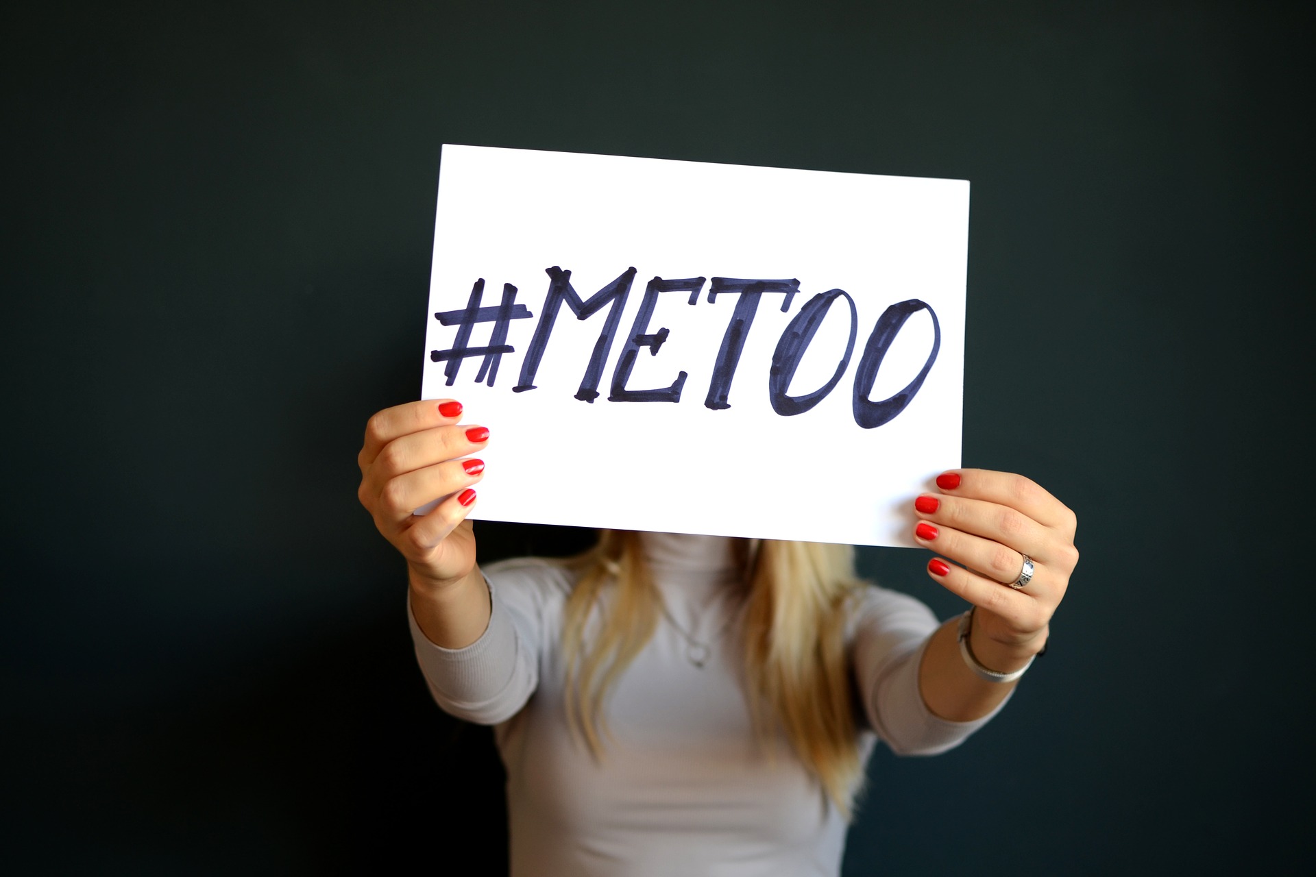 A woman holding a #metoo sign